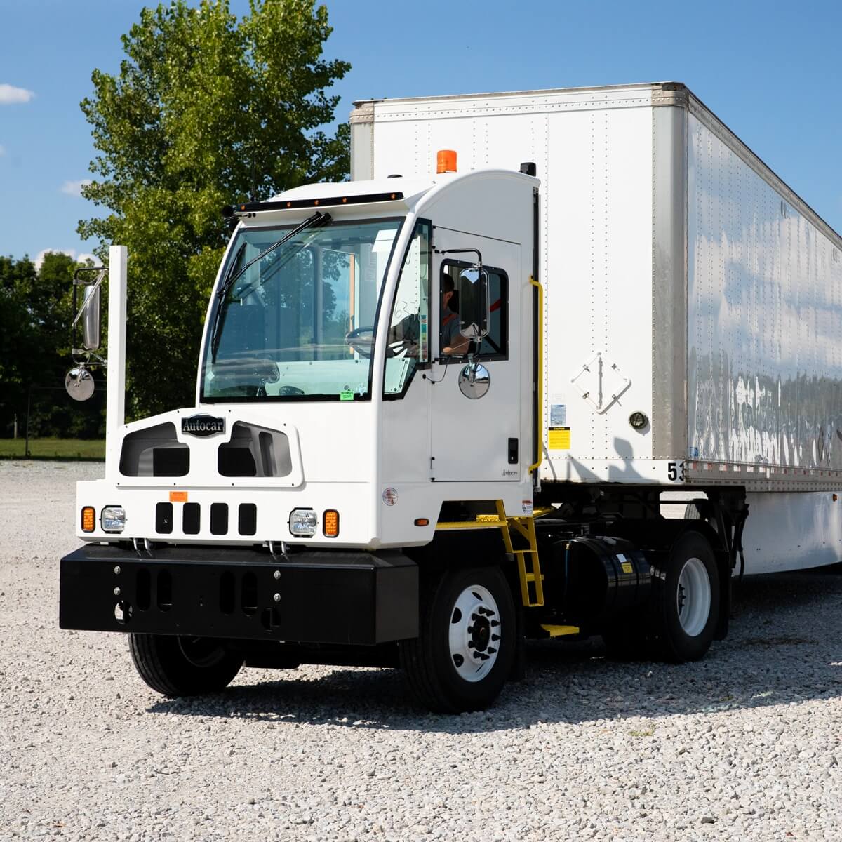 White Autocard Yard Truck with attachments.