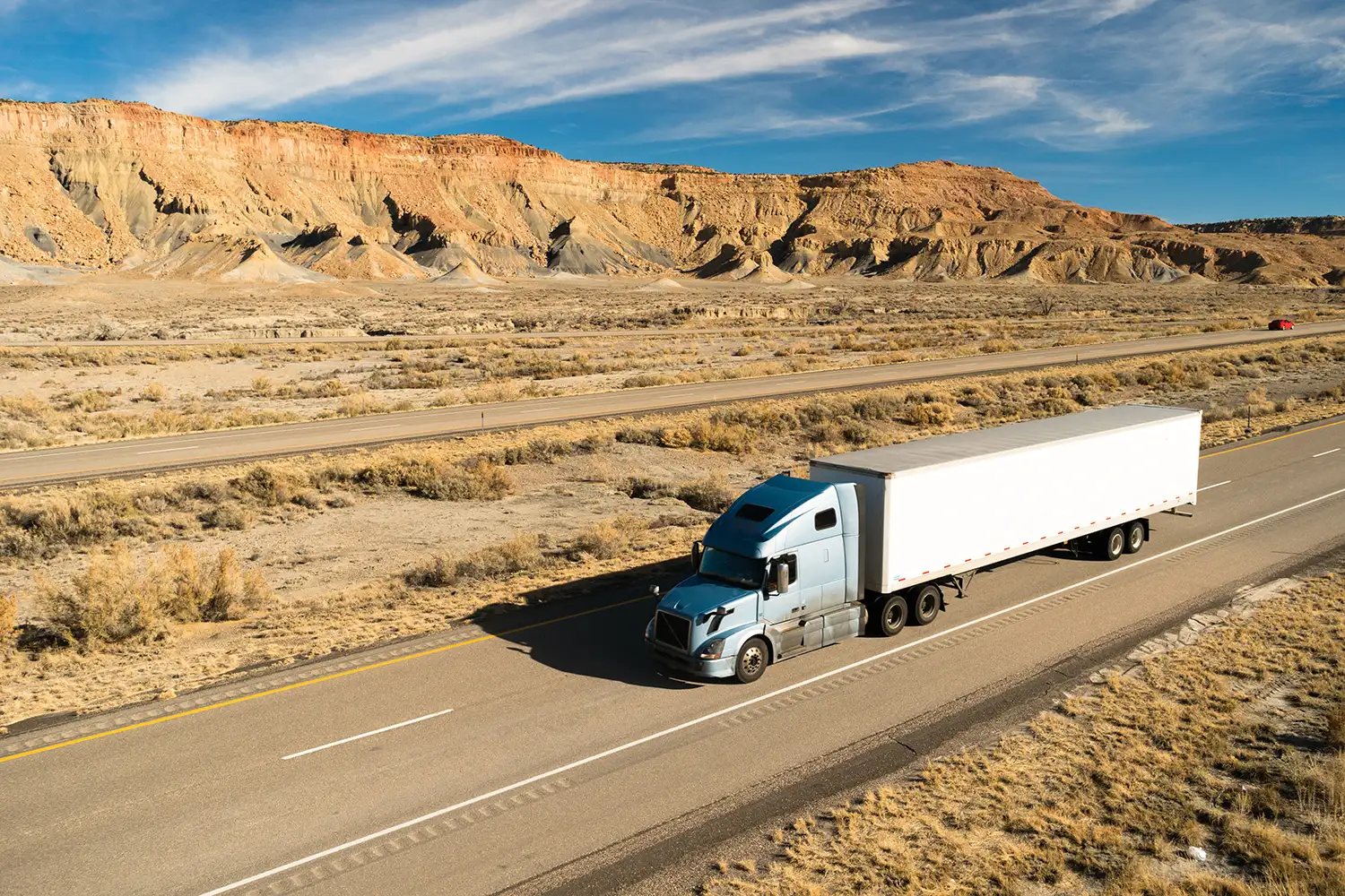 Dry van truck and trailer on a highway.