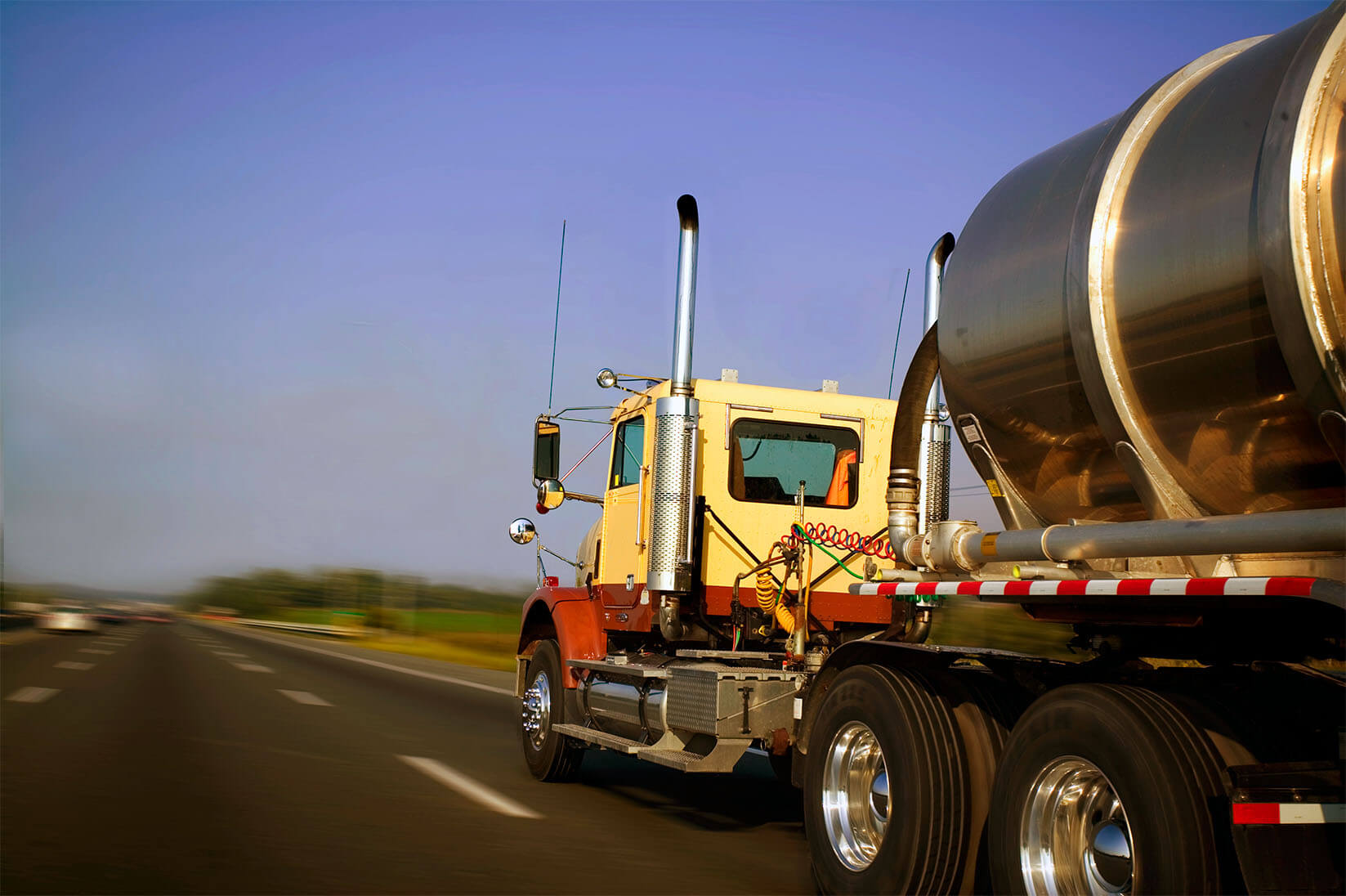 A semi hauling liquid in a stainless steel liquid transport trailer.
