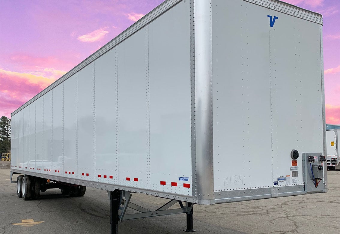 The front corner of a vanguard trailer durring a sunset.
